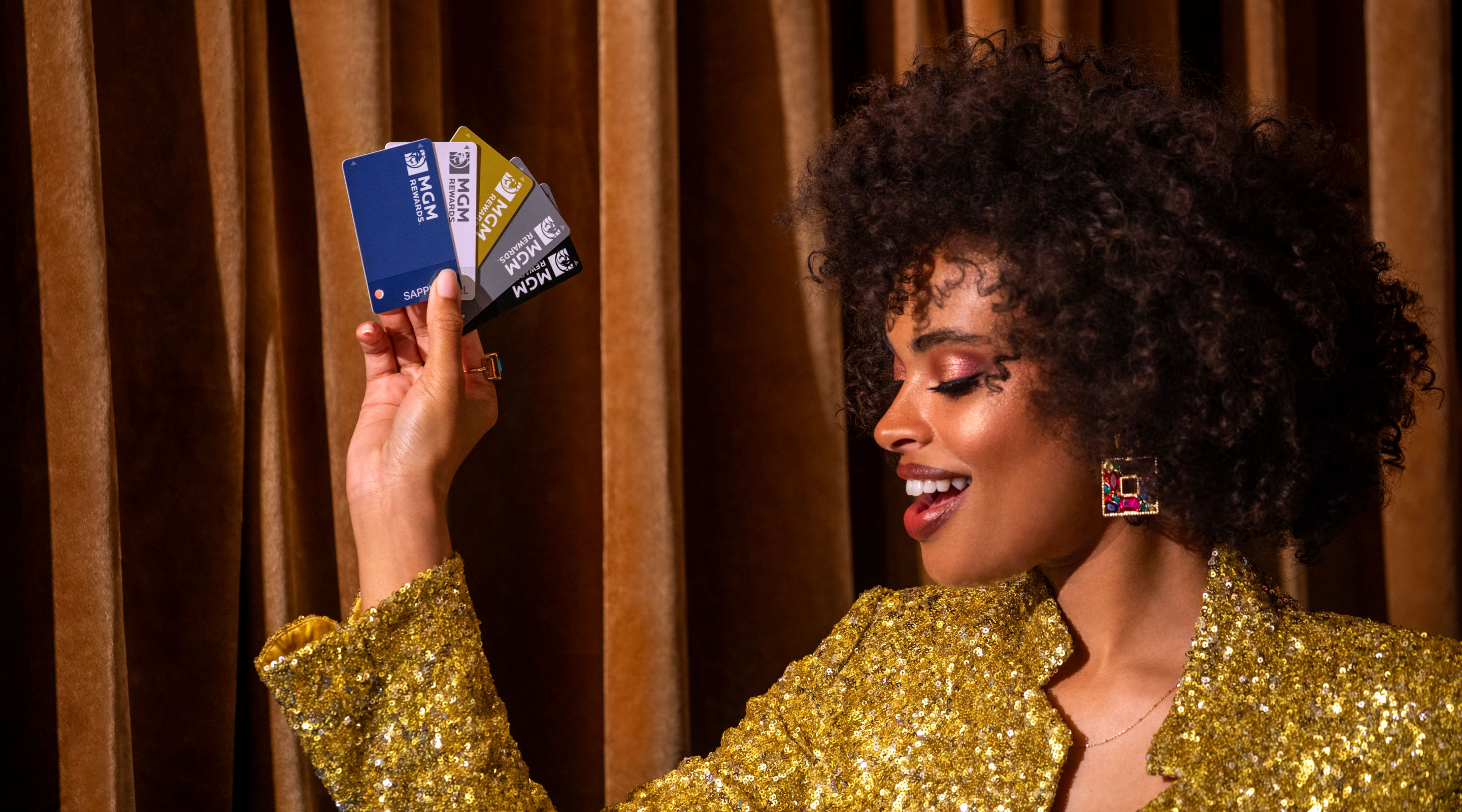 A woman holding MGM Rewards cards