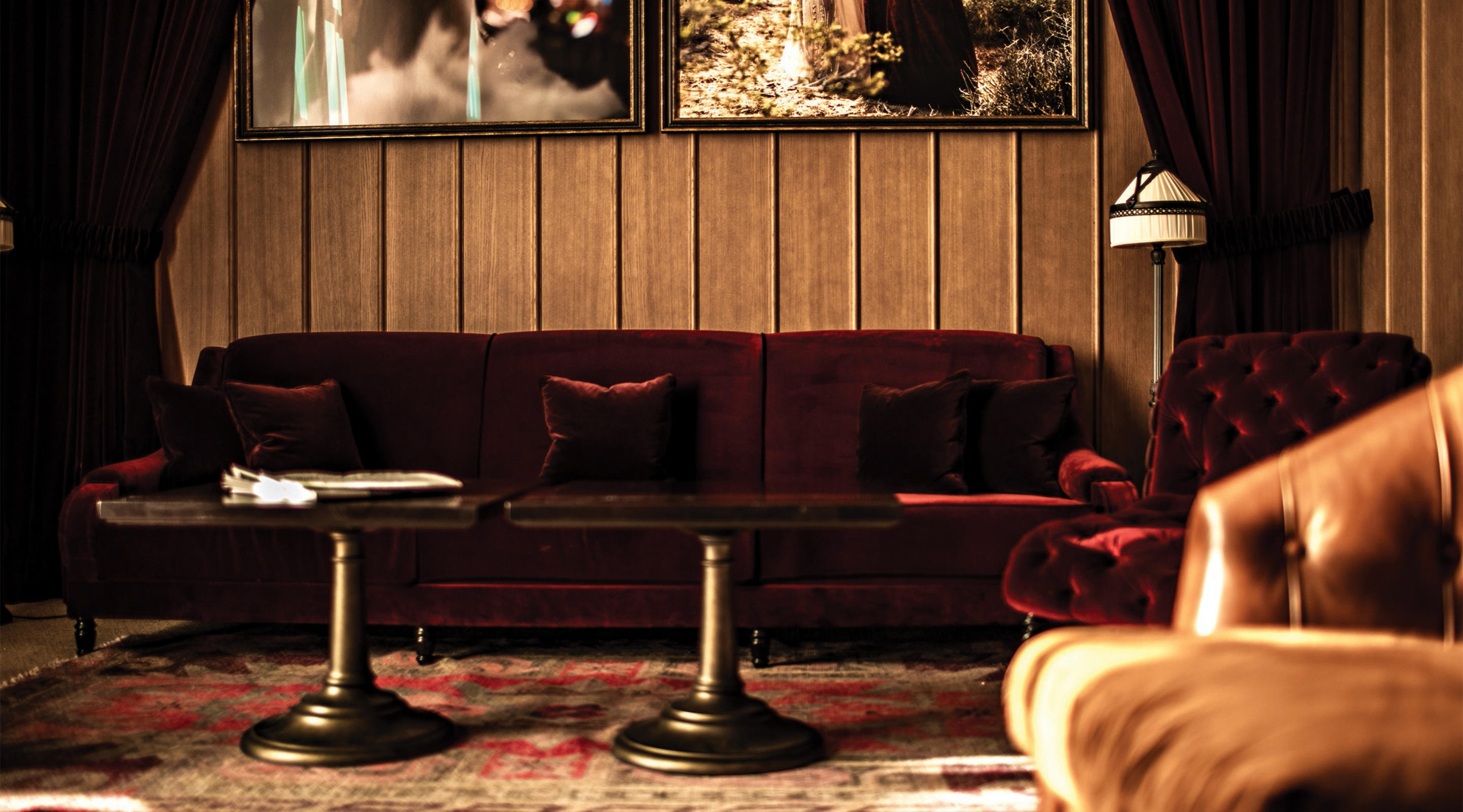 A red velvet couch inside NoMad Bar.
